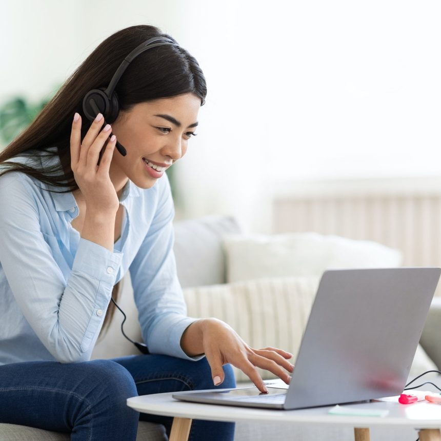 Asian-Woman-Studying-Foreign-Languages-Online-With-Laptop-And-Headset-At-Home.jpg